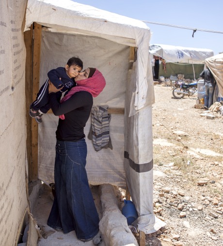 A Syrian refugee kisses her son.