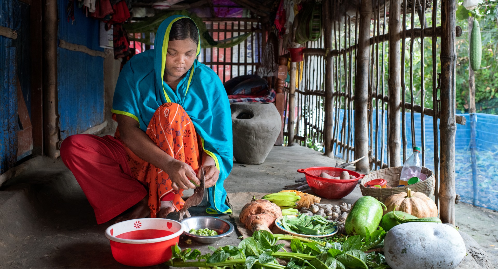 A woman prepares vegetables and fruits for a family meal.
