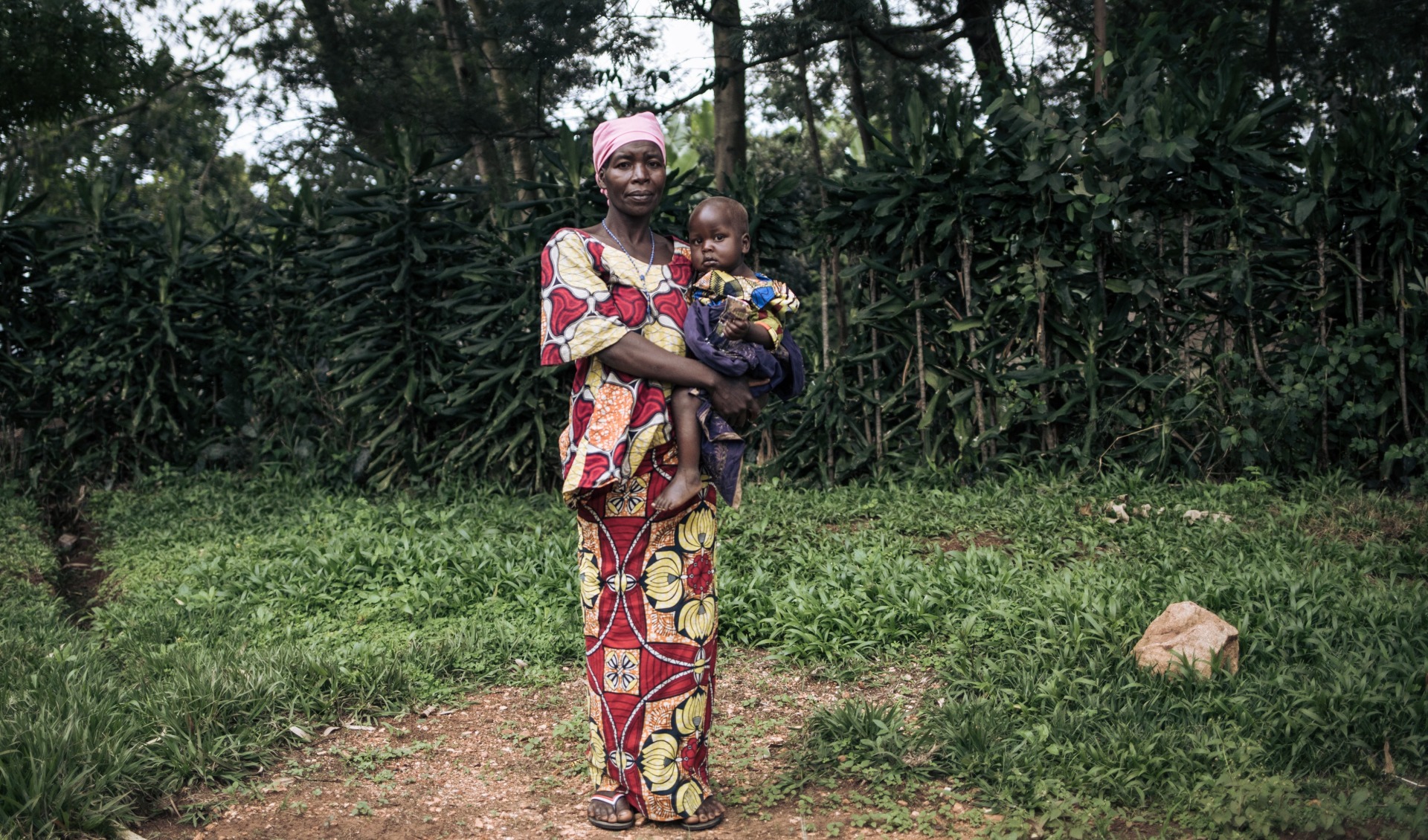 Georgine Dz'dha Nzale holds her 27-month-old son, David Wauba, who suffers from severe acute malnutrition, near the Drodro Health Center in Ituri, northeastern Democratic Republic of Congo.