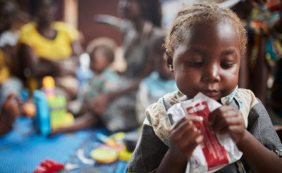 A child eats Plumpy'Nut, the ready-to-use therapeutic food that can bring malnourished children from a medical crisis to full health in as little as 45 days.